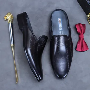 Polished black leather pointed-toe mules with artistic embossed text and low-heel structure