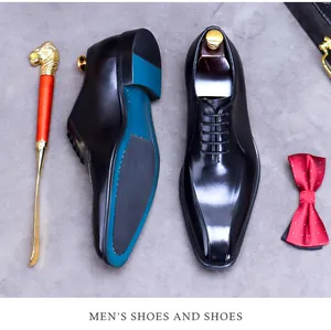 Detailed shot of shiny leather Oxford shoes with blue sole accent and elegant shoehorn