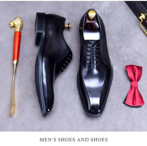 Flat lay of luxury black leather oxford shoes with a bow tie and stylish accessories