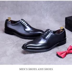 Detail of premium black leather oxfords with red bowtie and branded gift box