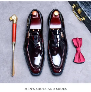 Close-up of polished oxblood monk strap leather shoe with elegant gold buckle and accessories