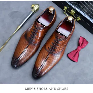 Close-up of brown leather dress shoes with crocodile texture and woven patterns