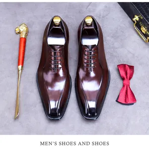 Detail of brown leather oxford shoes with gradient toe and metallic lion shoehorn