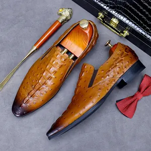 Brown crocodile and ostrich pattern leather loafers with luxury shoe trees and accessories