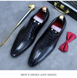 Detail of luxury men's pointed toe dress shoes with crocodile texture and woven patterns