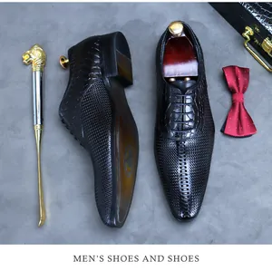 Top view of black leather oxford shoes with crocodile texture and woven pattern details