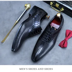 Detail of luxury men's black leather oxfords with snake skin texture and woven patterns
