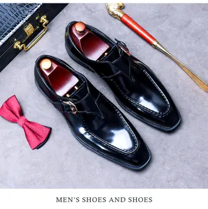 Detail of glossy black leather monk strap shoe with silver buckle and wooden shoe tree