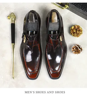 Flat lay of brown monk strap leather shoes with a gold lion head shoe horn