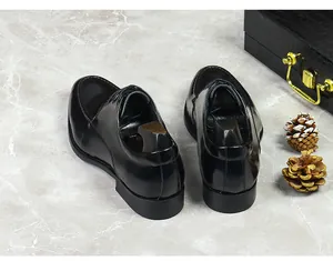 Macro detail of glossy black leather business shoes with shoelaces on marble background