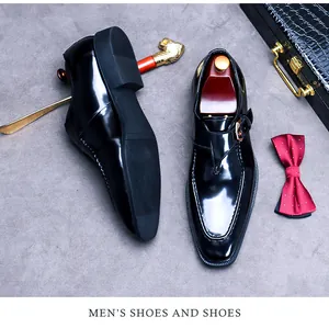 Detailed top view of black patent leather monk strap shoes with formal accessories