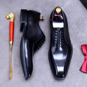 Polished black leather dress shoes for men with shoe trees and formal accessories
