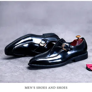 Detail of glossy black monk strap shoes with gold buckle and wooden shoe tree accent