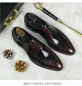 Macro shot of glossy polished leather shoes with U-tip stitching and premium metal shoe trees