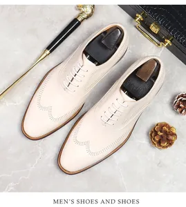 Detailed view of beige brogue leather shoes with laces and premium business accessories