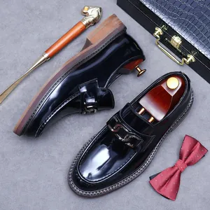 Men's polished black leather loafers with metal chain and classic round toe design
