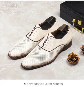 Makroaufnahme der perforierten weißen Leder-Oxfordschuhe mit braunen Zierleisten Details