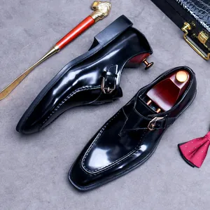 Polished black leather monk strap dress shoes with elegant buckle and premium styling