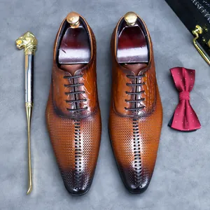 Brown leather oxfords with crocodile texture and pointed toe for business suits
