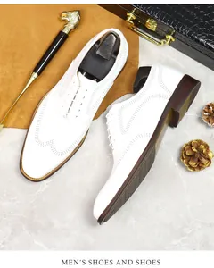 Top view of white leather Brogue shoes with wingtip perforations and classic lacing