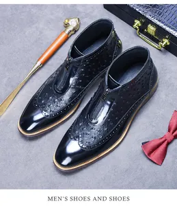 Detailed top view of black ostrich texture leather boots with front metal zipper design