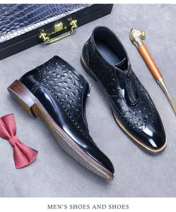 Detail of ostrich embossed black leather boot with front zipper and brogue patterns