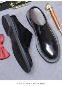 Top view of glossy black leather mules with thick rubber sole and round toe design