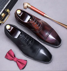 Detail of Brogue leather Oxford shoes with wingtip carving and polished finish