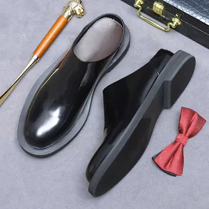 Polished black leather pointed mule shoes for men in a professional business setting