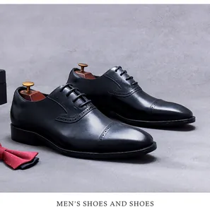 Detail of classic black leather brogue shoes with intricate perforated wingtip patterns