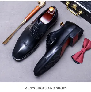 Detailed top view of black leather cap-toe Oxford shoes with anti-slip wave soles