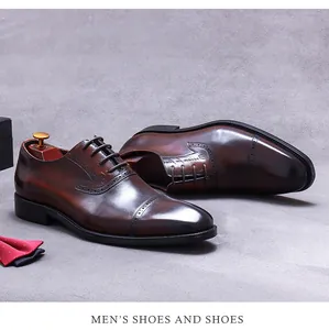 Macro shot of brown leather brogue shoes with burnished finish and wingtip details