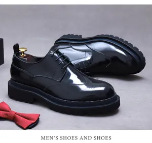 Detail van zwarte lederen Derby schoenen met brogue-snijwerk en dikke rubberen zolen