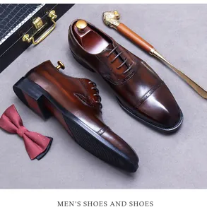 Close-up of brown leather Oxford shoes with brogue details and gentleman accessories