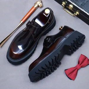 Men's dark brown patent leather monk strap shoes with thick soles on a luxury background