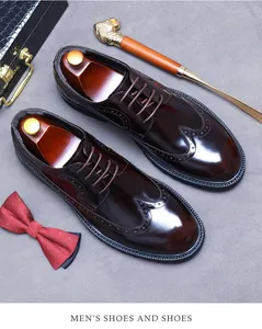 Vue à plat de chaussures richelieu en cuir marron avec de fines perforations et accessoires