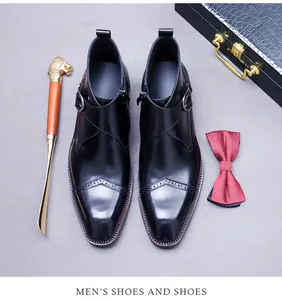 Detail of black leather monk strap boots with brogue carving and side zipper for men