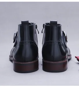 Close-up of black leather boots with Brogue carving details and side zipper closure