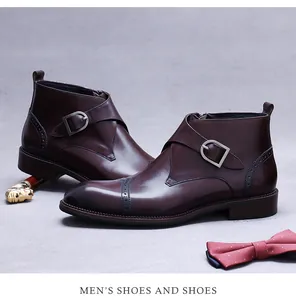 Detail of dark brown leather monk strap boots with brogue carving and side zipper