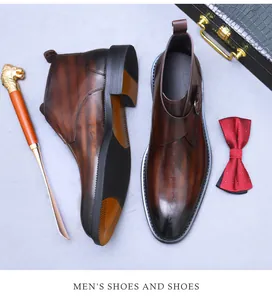 Detail of men's leather boots showing calligraphic print, metal buckle and non-slip sole