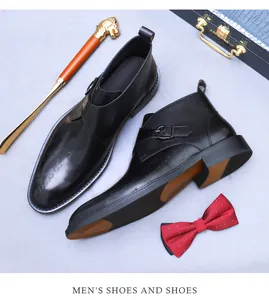 Close-up of black leather monk strap boots with metal buckle and premium accessories