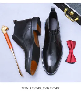 Detail of black leather monk strap boots with stylish side buckle and side engraving