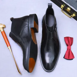 Men's leather monk strap boots with side engraving and a premium polished finish