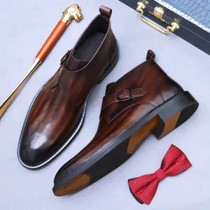 Men's brown leather monk strap boots with laser-etched script and vintage finish