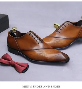 Detail of brown leather oxford shoes featuring intricate crest engraving and gradient finish