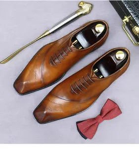 Detail view of brown leather oxfords with laser-engraved text and gradient toe