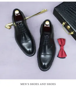 Chaussures richelieu noires en cuir à triple couture avec nœud papillon et chausse-pied