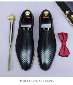 Macro detail of black perforated leather shoes with luxury business lifestyle accessories
