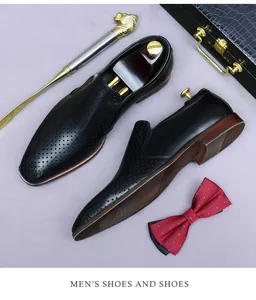 Detailed close-up of black hollow-out leather loafers with breathable perforated design