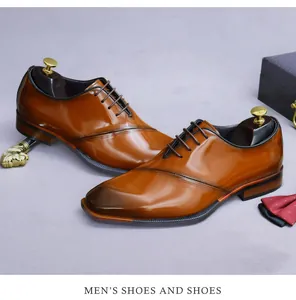 Close-up of caramel brown leather oxford shoes with gradient toe and business accessories